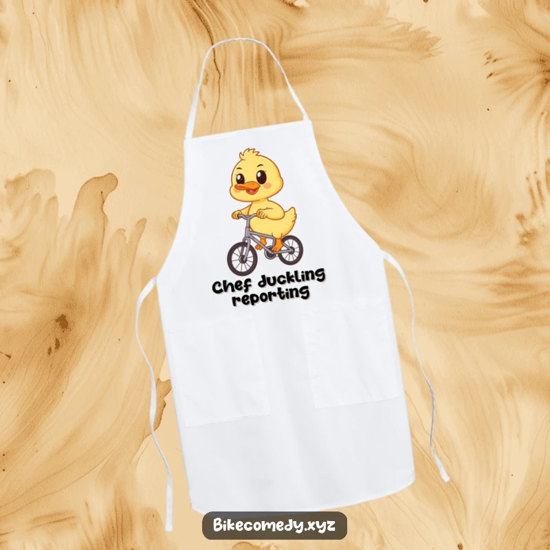 Funny duckling apron depicting a determined duckling pedaling a small bicycle, perfect for adding a humorous and cute touch to kitchen duties.